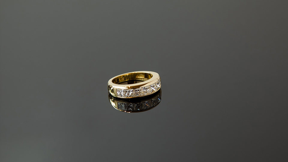 Diamond and gold ring on glass
